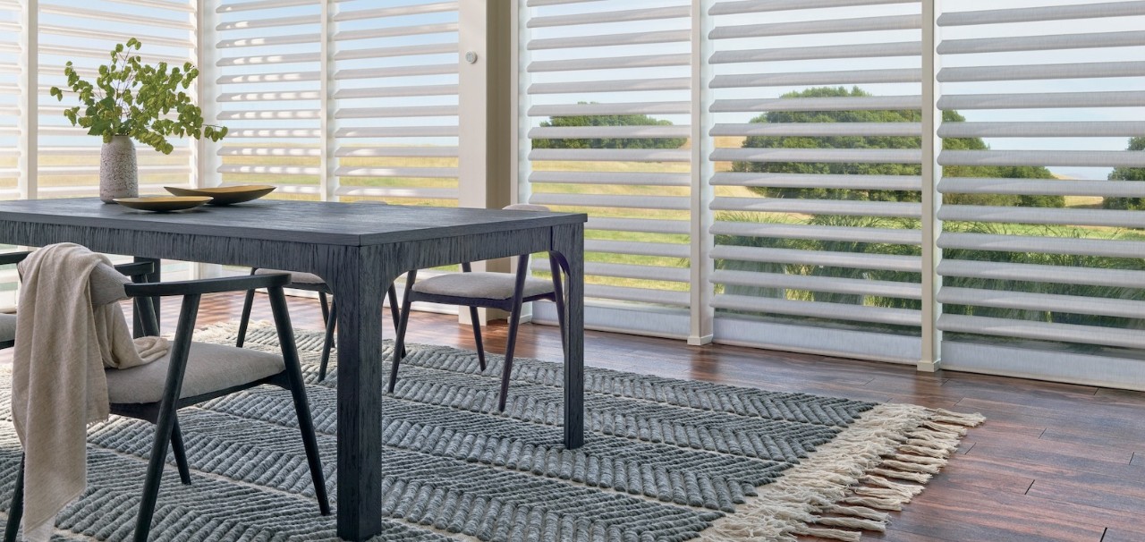 A dining room with a beautiful area rug.